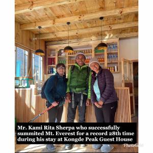 a group of people posing for a picture in a room at Kongde Peak Guest House in Phakding