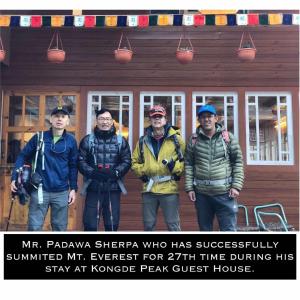 a group of men standing in front of a cabin at Kongde Peak Guest House in Phakding