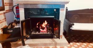 a fireplace with a fire inside of it at Casa Rural Chorrito 1 in La Alberca