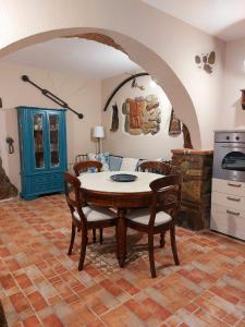 a kitchen with a table and chairs in a room at Villetta Blu in Rio nellʼElba +30 photos