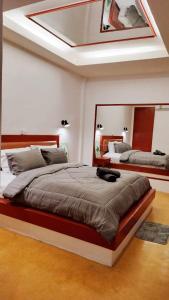 a bedroom with two beds and a mirror at Mindful Kinesics Wellness Living in Amphoe Koksamui