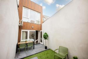 a balcony of a house with a table and chairs at Historical 80m2 Retreat with Sauna option in Eindhoven