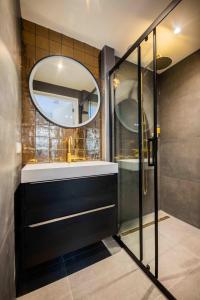 a bathroom with a sink and a mirror at Historical 80m2 Retreat with Sauna option in Eindhoven