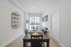 a dining room with a table and chairs at Comfortable Apartment in Charming Wynwood in Miami