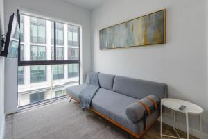 a living room with a couch and a large window at Comfortable Apartment in Charming Wynwood in Miami