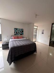 a bedroom with a large bed in a room at apartamento completo en Cañaveral in Cañaveral