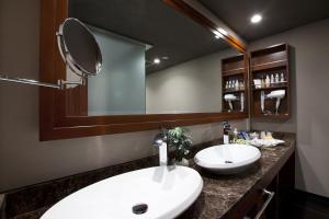 a bathroom with two sinks and a large mirror at Hotel Alfa Kyoto in Kyoto