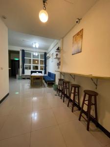 a living room with a table and stools at Yilan B&B in Jincheng