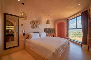 a bedroom with a large bed and a large window at Bstudio in APEC Mandala Mũi Né in Phan Thiet