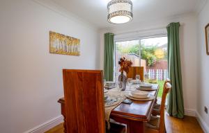 a dining room with a table and a window at Fennec 4-BR Detached House, Sleeps 6, Free Parking in Cambridge