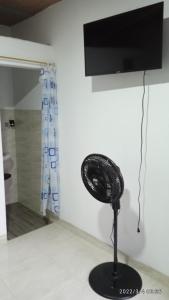 a black fan sitting on the floor next to a wall at Hostal Arámbulo in Villavieja