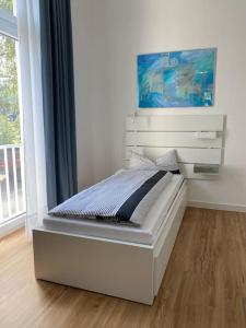 a white bed in a room with a window at Apartment Nr. 2 Bad Laasphe Altstadt in Bad Laasphe