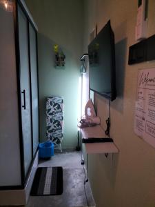 a small room with a sink and a window at Le Melur Single Bed in George Town