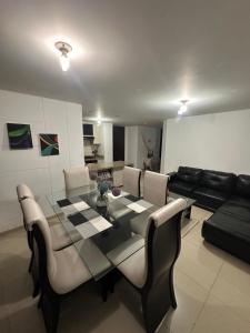 a living room with a glass table and a couch at apartamento completo en Cañaveral in Cañaveral