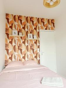 - une chambre avec un lit blanc et un mur en bois dans l'établissement Petite maison proche du métro, à Bagnolet