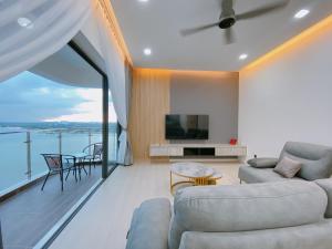 a living room with a couch and a tv at Seafront Country Garden Danga Bay by Lions Bay in Johor Bahru