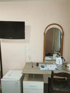 a bathroom with a counter with a mirror and a sink at Family Hotel Santo Bansko in Bansko +45 photos