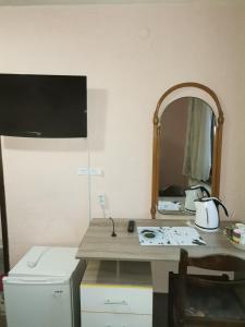 a bathroom with a counter with a mirror and a sink at Family Hotel Santo Bansko in Bansko