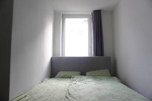 a bedroom with a bed in front of a window at Apartment in Gelsenkirchen - Gemütliche City-Suite in Gelsenkirchen