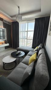 a living room with a couch and a table at Luxury 2 bedroom new brand in Ajman 
