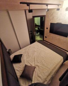 a bedroom with a bed and a flat screen tv at Ice Dream Apartmani in Kopaonik