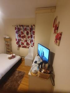 a bedroom with a desk with a computer on it at Double size and Single room in Barking in Barking