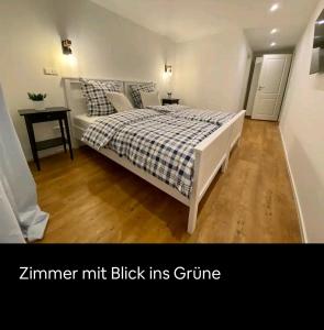 a bedroom with a bed with a checkered blanket at Reiter's Apartments am Eichelberg in Gaggenau