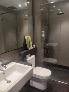 a bathroom with a sink and a toilet and a mirror at EasyStay Genting Vista Residences 3 Bedrooms- High Floor FREE WiFi, TV Box & 1 Parking #Up to 10pax in Genting Highlands