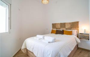 a bedroom with a large white bed with towels on it at Nice Apartment In Arcos De La Frontera in Arcos de la Frontera