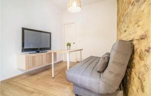 a living room with a couch and a tv and a table at Nice Apartment In Arcos De La Frontera in Arcos de la Frontera +10 photos