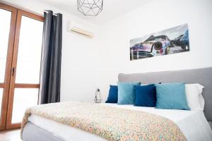 a bedroom with a bed with blue pillows at Room 500 in Siano
