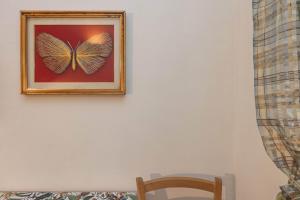 a picture of a butterfly on a white wall at Extravacanza Central Station in Bari