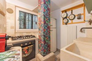 a kitchen with a stove and a sink at Extravacanza Central Station in Bari +22 photos
