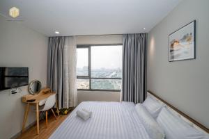a bedroom with a bed and a desk and a window at Cozy Apartment in District 4-City Center - Free Netflix - canhogiatot24h in Ho Chi Minh City