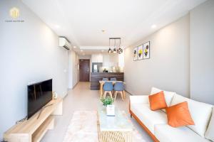 a living room with a white couch and a table at Cozy Apartment in District 4-City Center - Free Netflix - canhogiatot24h in Ho Chi Minh City