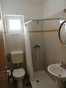 a small bathroom with a toilet and a sink at Ivana in Fažana