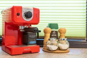 a red mixer sitting on top of a counter at Marc's SELF CHECK-IN with free parking in Oradea