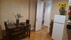 a kitchen with a table and a refrigerator at Good Morning...princeSa in Valladolid