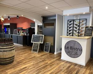 a wine store with a display of wine bottles at Hotel The Originals Romans-sur-Isère Le Clos des Tanneurs in Romans-sur-Isère