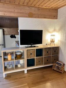 a white entertainment center with a television on top at Hanna's Home in Kitzbühel