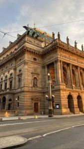 a large building with a statue in front of it at Sunny flat in center of Prague in Prague