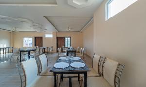 a long dining room with tables and chairs at Treebo Trend Raj Palace in Varanasi