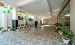 a hallway with potted plants in a building at Treebo Trend Raj Palace in Varanasi