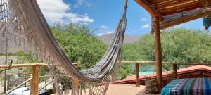 a hammock on a deck with a view at La Arenosa in Cafayate