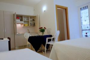 a room with a table and chairs and a kitchen at B&B - Hotel Blurelda in Silvi Marina