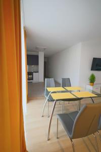 una sala de conferencias con mesas y sillas y una cocina en Reymonta 22 Apartamenty en Opole