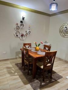 a dining room table with chairs and a pumpkin on it at Home in Kira Namugongo. in Kira