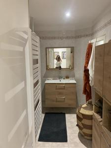 a bathroom with a sink and a mirror at le dit vin secret in Aigues-Mortes