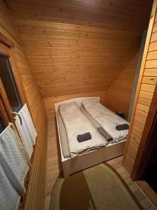 a small room with a bed in a sauna at Forest Guest House in Sîntimbru-Băi