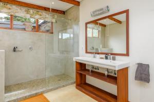 a bathroom with a sink and a shower at Zulu Waters Game Reserve in Estcourt